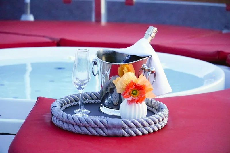 Euphoria II Yacht Photos Pics Luxury setup on Mayra Yachts 50m, 2016, featuring champagne and flowers by a jacuzzi.