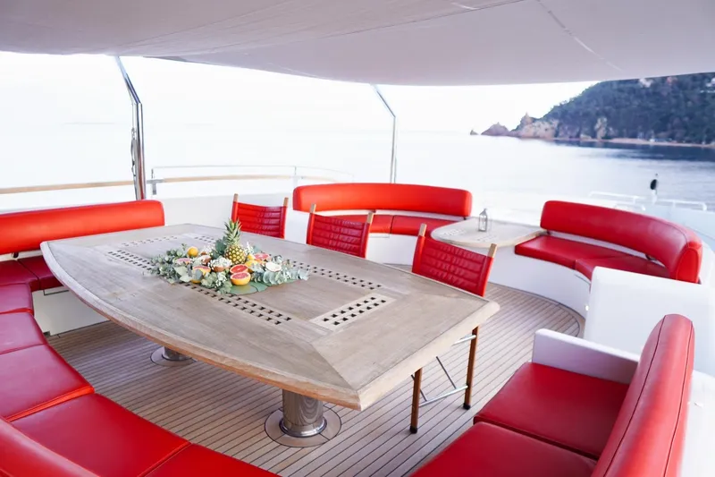 Euphoria II Yacht Photos Pics Luxurious Mayra Yachts 50m deck with red seating and elegant dining table, 2016 model.