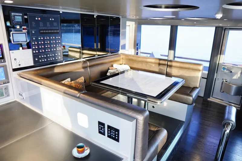 Euphoria II Yacht Photos Pics Luxurious interior of 2016 Mayra Yachts 50m, featuring a modern seating area and control panel.