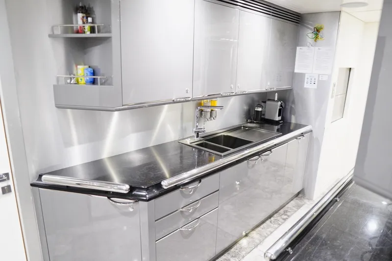 Euphoria II Yacht Photos Pics Modern kitchen interior on 2016 Mayra Yachts 50m, featuring sleek cabinetry and stainless steel appliances.