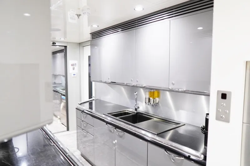 Euphoria II Yacht Photos Pics Modern kitchen interior on 2016 Mayra Yachts 50m, featuring sleek cabinetry and stainless steel finishes.