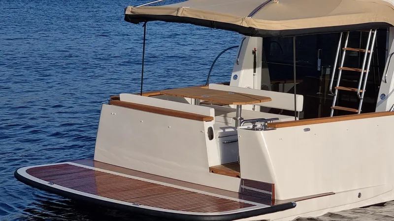 Monachus 470 Fly Yacht Photos Pics 2026 Monachus 470 FLY yacht with elegant deck and seating area on calm water.