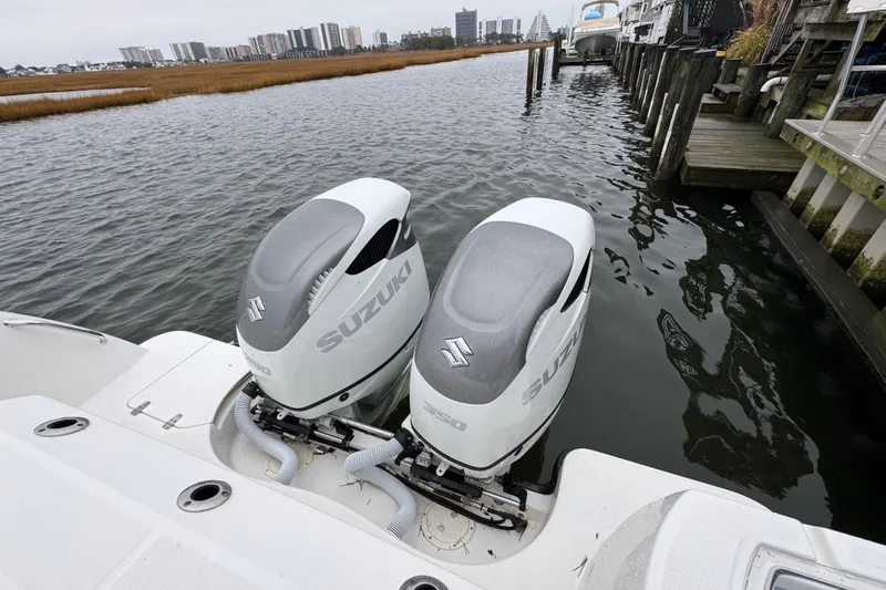 Hammer Down Yacht Photos Pics 2016 Boston Whaler 315 Conquest with twin Suzuki outboard engines docked by waterfront.