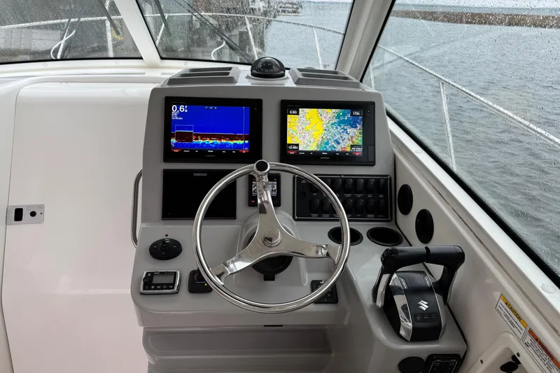 Hammer Down Yacht Photos Pics Helm of 2016 Boston Whaler 315 Conquest with navigation screens and controls.