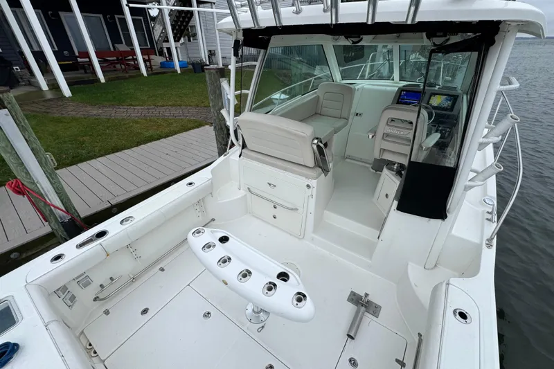 Hammer Down Yacht Photos Pics 2016 Boston Whaler 315 Conquest boat interior with seating and navigation equipment.