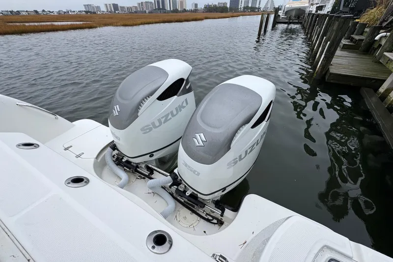 Hammer Down Yacht Photos Pics 2016 Boston Whaler 315 Conquest with twin Suzuki outboard engines docked by the water.