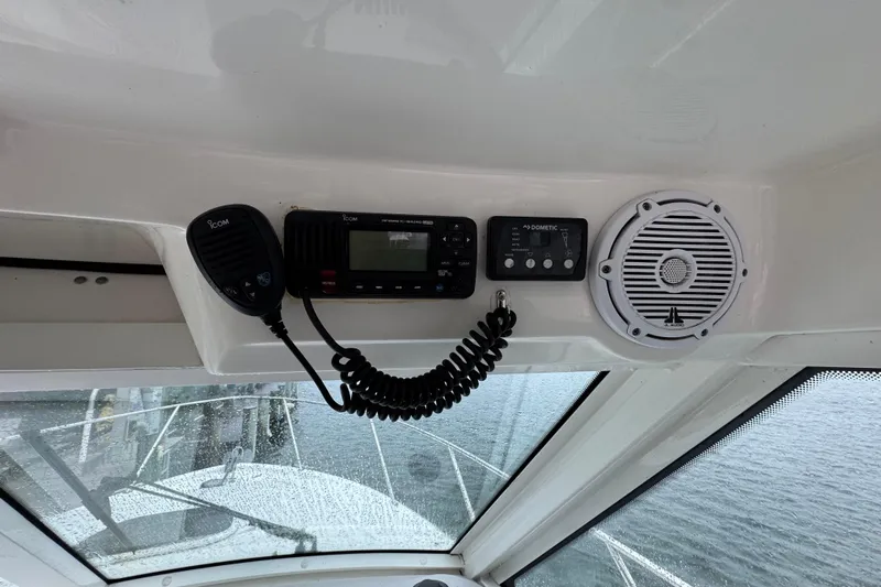 Hammer Down Yacht Photos Pics 2016 Boston Whaler 315 Conquest dashboard with radio, controls, and speaker.