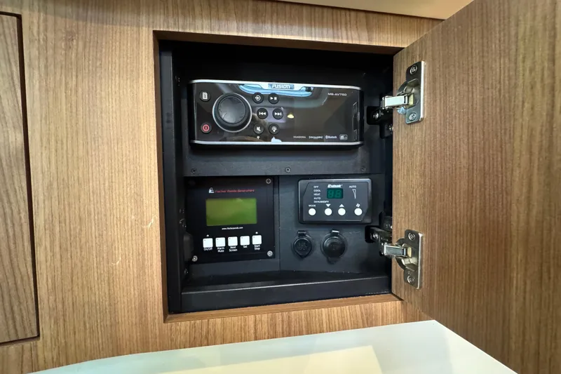 Hammer Down Yacht Photos Pics Control panel inside a 2016 Boston Whaler 315 Conquest boat, featuring audio and system controls.