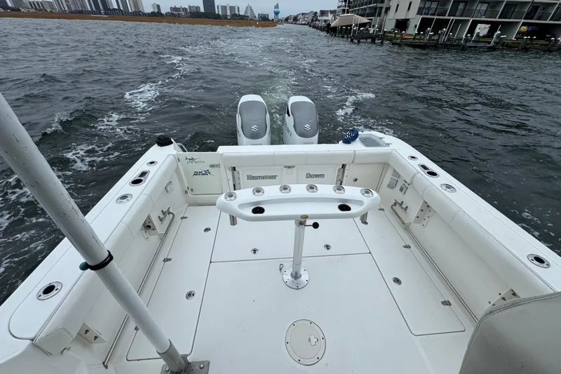 Hammer Down Yacht Photos Pics 2016 Boston Whaler 315 Conquest boat deck with dual engines on water.