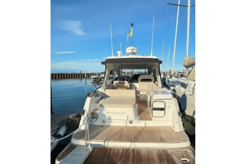  Yacht Photos Pics 2022 Beneteau Gran Turismo 36 yacht docked at marina, showcasing spacious deck and seating.