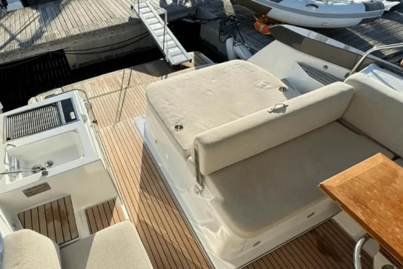  Yacht Photos Pics 2022 Beneteau Gran Turismo 36 yacht deck with seating and kitchenette area.