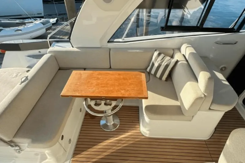  Yacht Photos Pics Luxurious seating area on 2022 Beneteau Gran Turismo 36 yacht with wooden table.