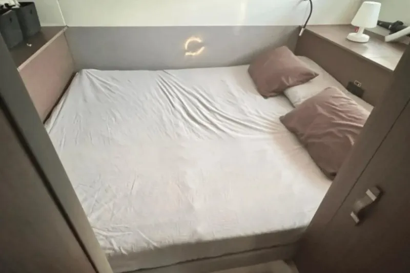  Yacht Photos Pics Cozy bedroom interior of 2022 Beneteau Gran Turismo 36 yacht with double bed and pillows.