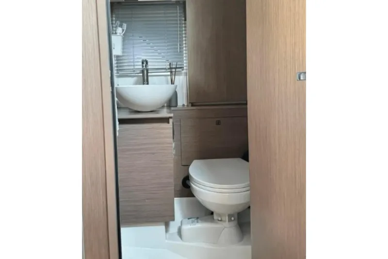  Yacht Photos Pics Modern bathroom in 2022 Beneteau Gran Turismo 36 yacht, featuring sleek design and fixtures.