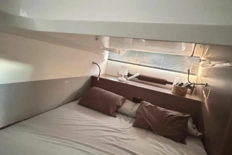  Yacht Photos Pics Cozy cabin interior of 2022 Beneteau Gran Turismo 36 yacht with bed and reading lights.