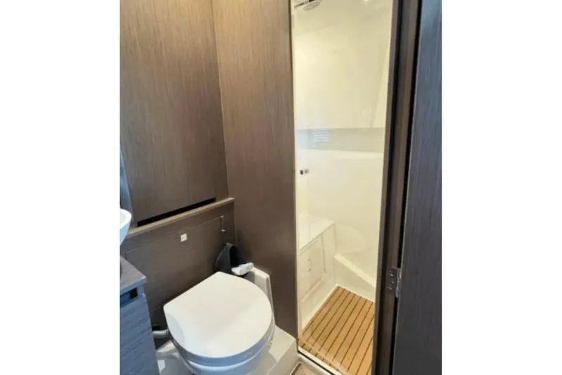  Yacht Photos Pics Bathroom interior of 2022 Beneteau Gran Turismo 36 yacht, featuring modern design and wooden accents.