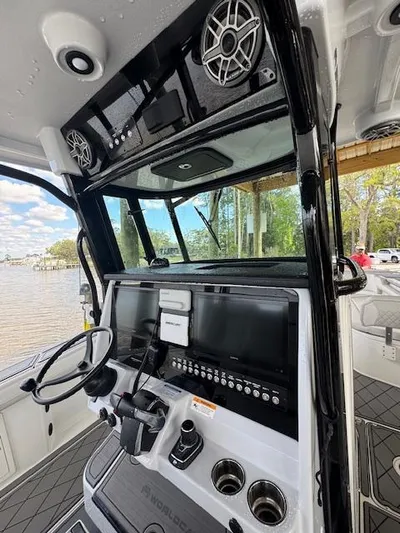 Nauti Time Yacht Photos Pics 2024 World Cat 325 CC boat dashboard with steering wheel and control panel.