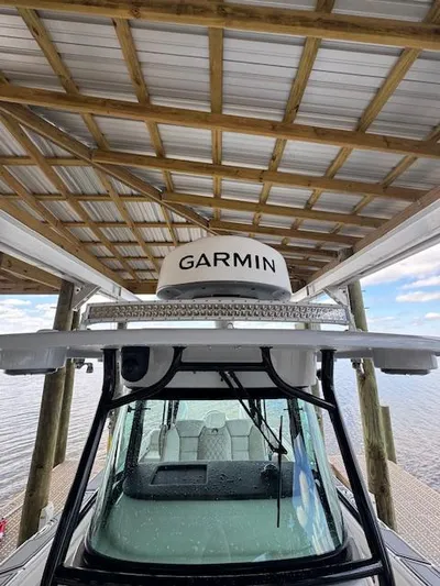 Nauti Time Yacht Photos Pics 2024 World Cat 325 CC boat with Garmin equipment under a dock roof.