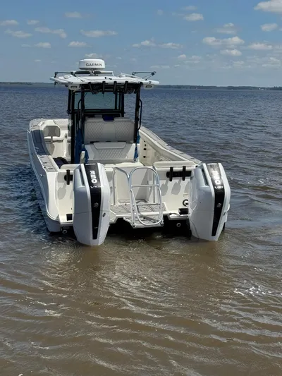 Nauti Time Yacht Photos Pics 2024 World Cat 325 CC boat on water, featuring dual engines and open deck design.