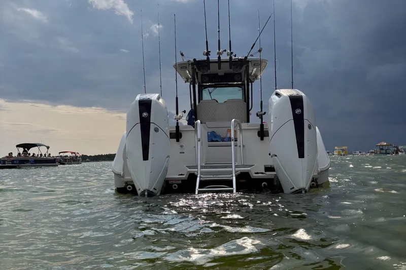 Nauti Time Yacht Photos Pics 2024 World Cat 325 CC boat on water, rear view with dual engines.