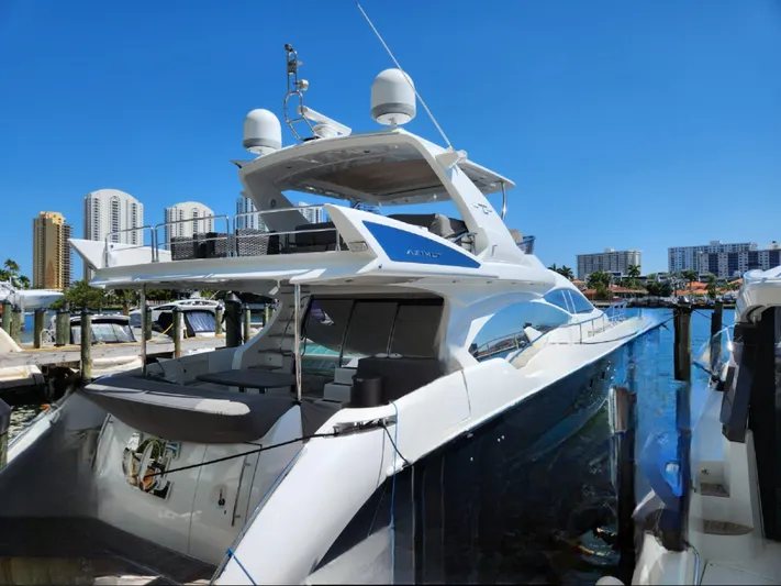  Yacht Photos Pics Azimut Flybridge 2014 yacht docked at marina, clear blue sky, urban skyline background.