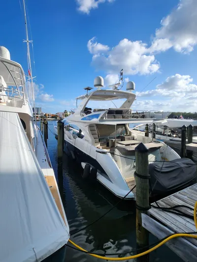  Yacht Photos Pics 2014 Azimut Flybridge yacht docked at marina under blue sky.