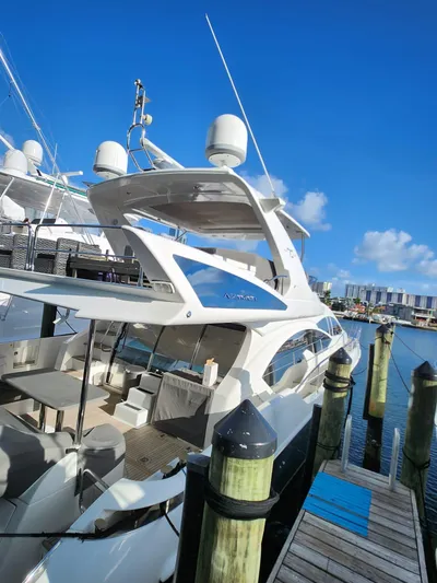  Yacht Photos Pics 2014 Azimut Flybridge yacht docked at marina under clear blue sky.
