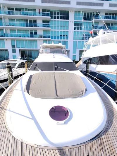  Yacht Photos Pics 2014 Azimut Flybridge yacht docked near modern waterfront building.
