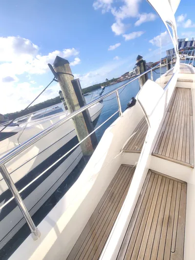  Yacht Photos Pics 2014 Azimut Flybridge yacht docked, featuring sleek design and wooden deck.