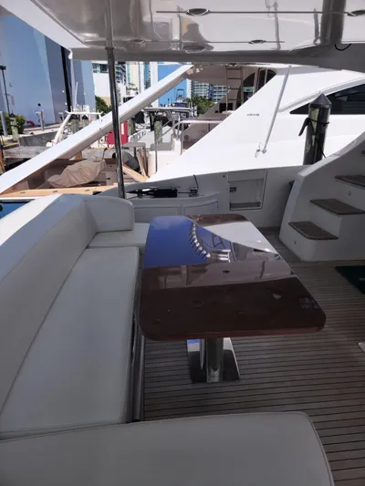  Yacht Photos Pics 2014 Azimut Flybridge yacht with sleek seating and polished table on deck.