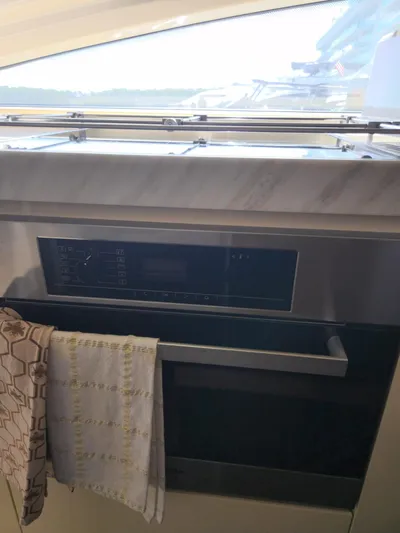  Yacht Photos Pics 2014 Azimut Flybridge yacht interior with modern kitchen appliance and towels.