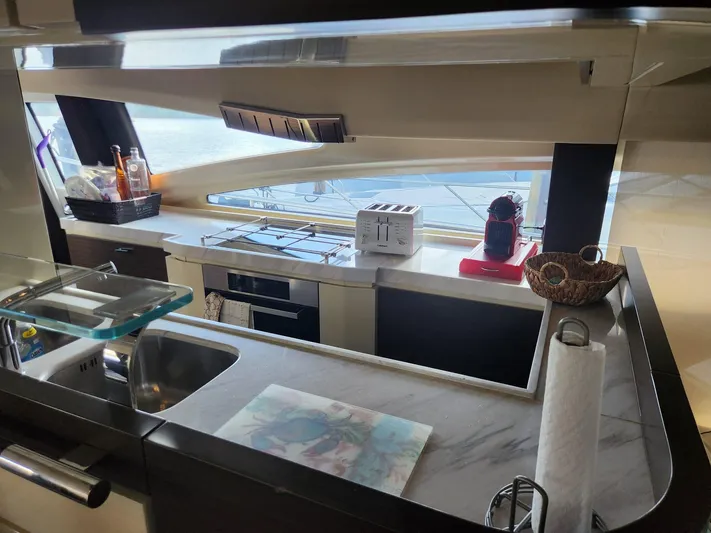  Yacht Photos Pics Modern kitchen interior of 2014 Azimut Flybridge yacht with appliances and sea view.
