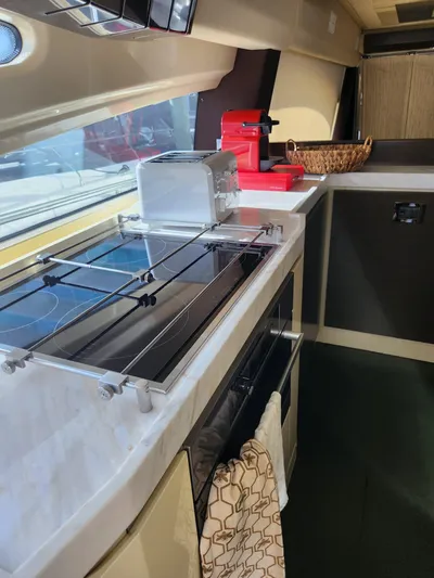  Yacht Photos Pics 2014 Azimut Flybridge yacht kitchen with stove, toaster, and coffee maker.