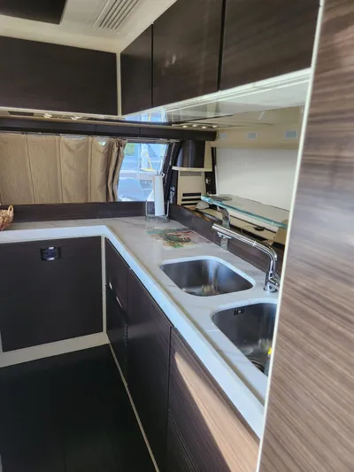  Yacht Photos Pics 2014 Azimut Flybridge yacht kitchen with modern cabinetry and dual sinks.