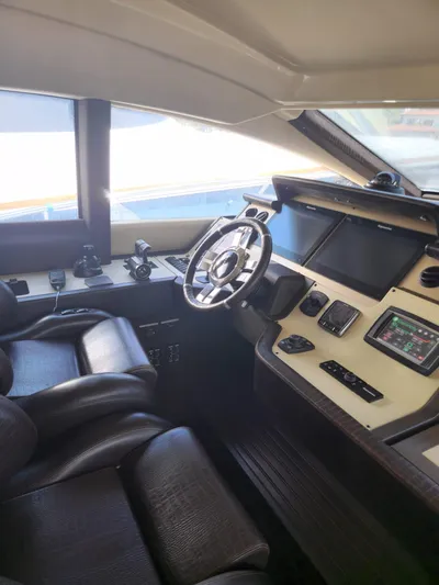  Yacht Photos Pics 2014 Azimut Flybridge yacht cockpit with modern navigation controls and leather seating.