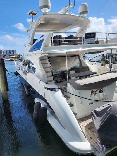  Yacht Photos Pics 2014 Azimut Flybridge yacht docked at marina under clear blue sky.