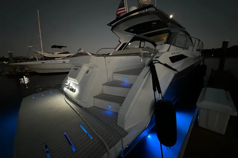 Bellisima Yacht Photos Pics 2019 Azimut Atlantis 51 yacht docked at night with blue underwater lights.