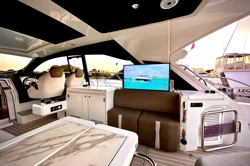 Bellisima Yacht Photos Pics Luxurious interior of 2019 Azimut Atlantis 51 yacht with modern seating and TV display.