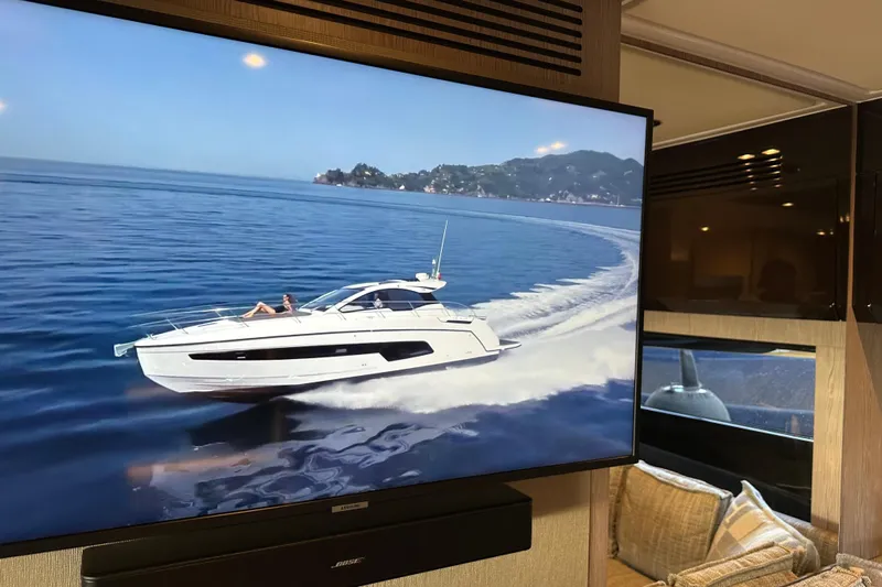 Bellisima Yacht Photos Pics 2019 Azimut Atlantis 51 yacht cruising on open water, displayed on a screen indoors.