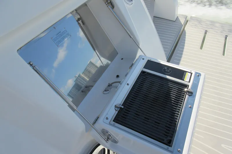 Bellisima Yacht Photos Pics Outdoor grill on 2019 Azimut Atlantis 51 yacht deck, reflecting sky and buildings.