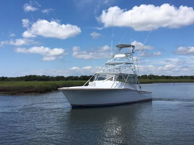 M.a.c. Daddy Yacht Photos Pics 2005 Custom DeSanti Carolina Express boat on calm water under blue sky.