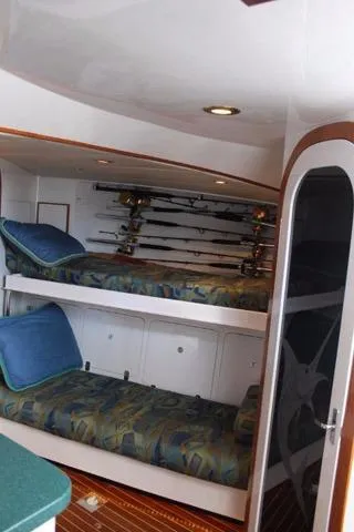 M.a.c. Daddy Yacht Photos Pics Interior of 2005 Custom DeSanti Carolina Express with bunk beds and fishing rods.