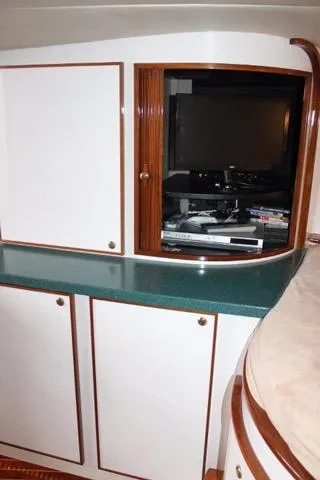 M.a.c. Daddy Yacht Photos Pics 2005 Custom DeSanti Carolina Express interior with TV and storage cabinets.