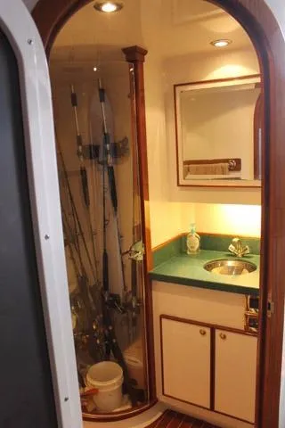 M.a.c. Daddy Yacht Photos Pics 2005 Custom DeSanti Carolina Express boat interior with fishing rods and compact sink area.