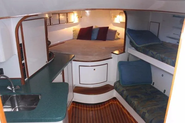 M.a.c. Daddy Yacht Photos Pics Interior of 2005 Custom DeSanti Carolina Express boat with cozy sleeping area and kitchenette.