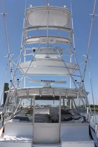 M.a.c. Daddy Yacht Photos Pics 2005 Custom DeSanti Carolina Express boat with tower, docked under clear blue sky.