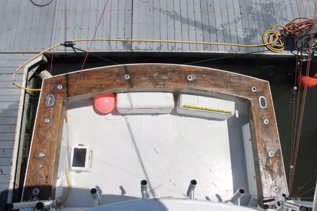 M.a.c. Daddy Yacht Photos Pics 2005 Custom DeSanti Carolina Express boat docked, featuring a wooden deck and fishing rod holders.