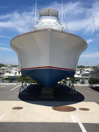M.a.c. Daddy Yacht Photos Pics Front view of 2005 Custom DeSanti Carolina Express boat on stands, clear sky background.