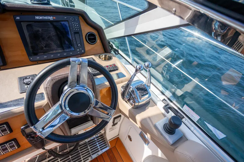  Yacht Photos Pics Cockpit of 2018 Cobalt 46 Yacht with steering wheel and navigation system.