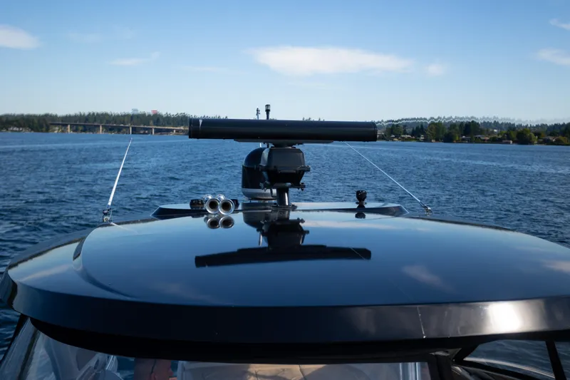  Yacht Photos Pics 2018 Cobalt 46 Yacht on serene lake with clear blue sky.